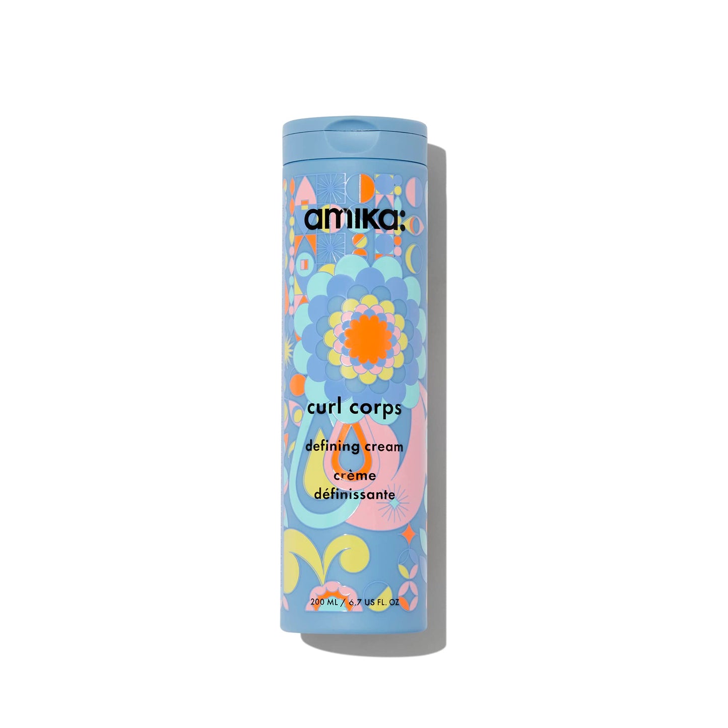 Amika Curl Corps defining cream container with colorful design on a white background